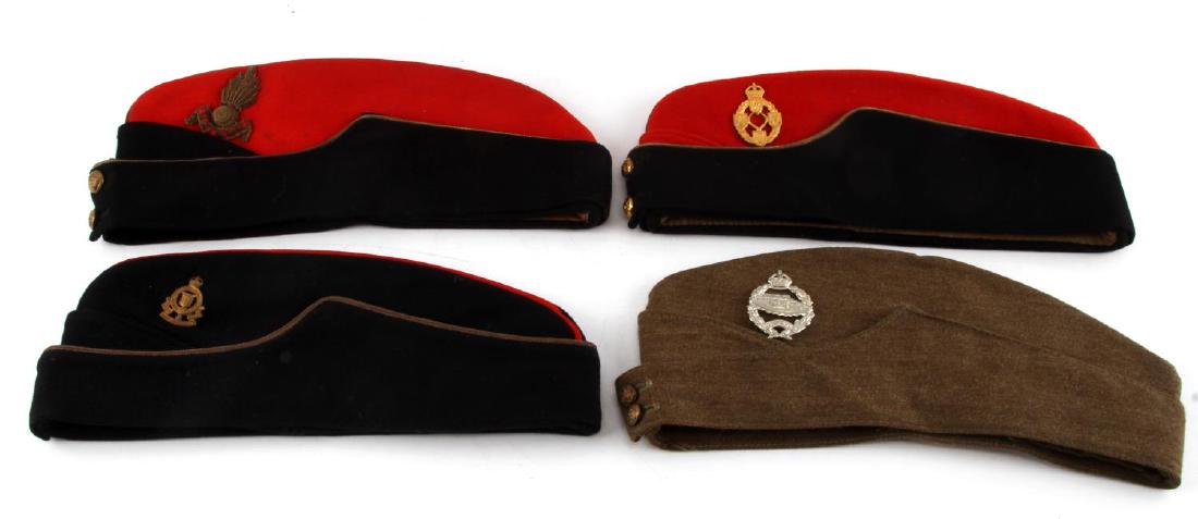GROUPING OF 4 WWII BRITISH MILITARY CAPS & HATS: Lot of 4 Military & police British Military caps / hats (Royal Artillery, Army Ordinance, & more). Each with a corresponding badge one of which reads "Royal Army Ordinance Corps", one badge bears imag