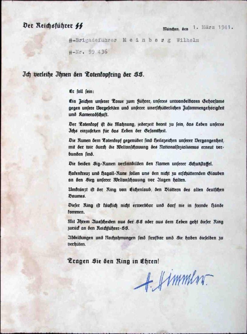 GERMAN WWII AWARD CITATOIN FOR SS HONOR RING: Issued for an SS Brigadenfuhrer Wilhelm Meinberg (1898-1973). Document features printed signature of Heinrich Himmler. Measures 8" x 10 3/4". Light staining. VG condition. Unauthenticated, sold as is.