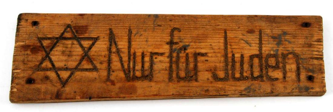 WWII THIRD REICH GERMAN ANTI SEMETIC PUBLIC SIGN: Wooden sign, measuring 12 inches by 4 inches with four holes for nails. The sign has a 6-pointed Star of David and Nur für Juden' (Only for Jews) on it. Likely from a park or other public location in