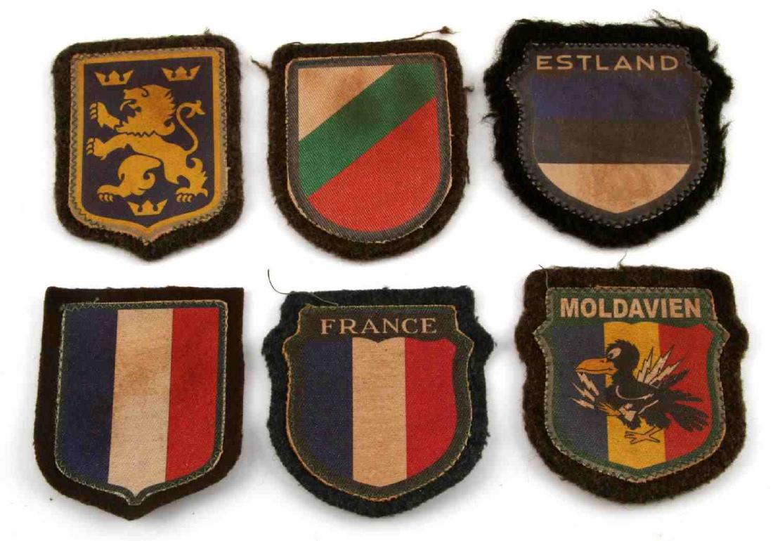 WWII GERMAN 3RD REICH FOREIGN VOLUNTEER PATCH LOT: Lot contains six patches for foreign volunteer regiments to the Wehrmacht. Includes Bulgarian, Estonia, Moldavian, two French, and one which is possibly Swedish. They are in very good condition. None 