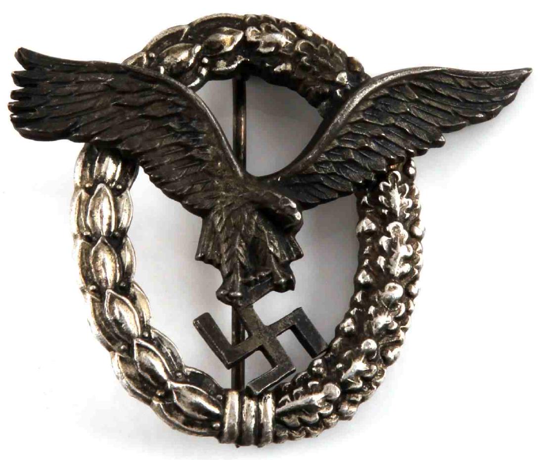 WWII GERMAN THIRD REICH LUFTWAFFE PILOTS BADGE: Two piece two domed rivet nickel construction. In very good condition with a thin vertical T style pinback. Unmarked reverse. VG condition, unauthenticated, sold as is.