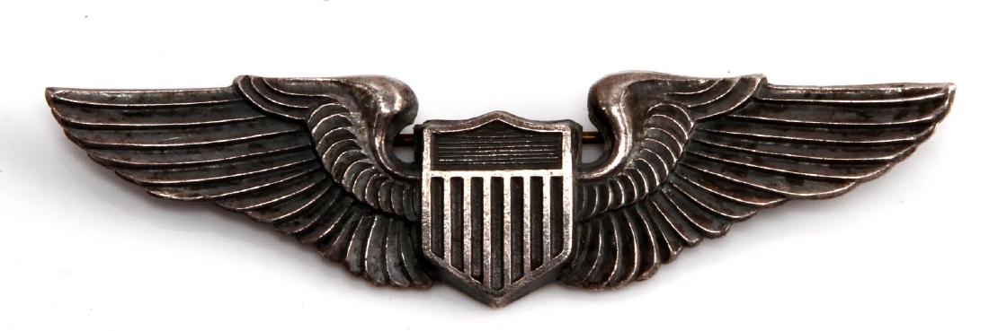 USAAF WWII UNITED STATES ARMY AIR FORCE PILOT WING: Australian made. Measures 3 1/16 inches wide by 13/16 inches tall. Maker marked "Angus & Coote Stg Sil". Has a thin English style pin back.