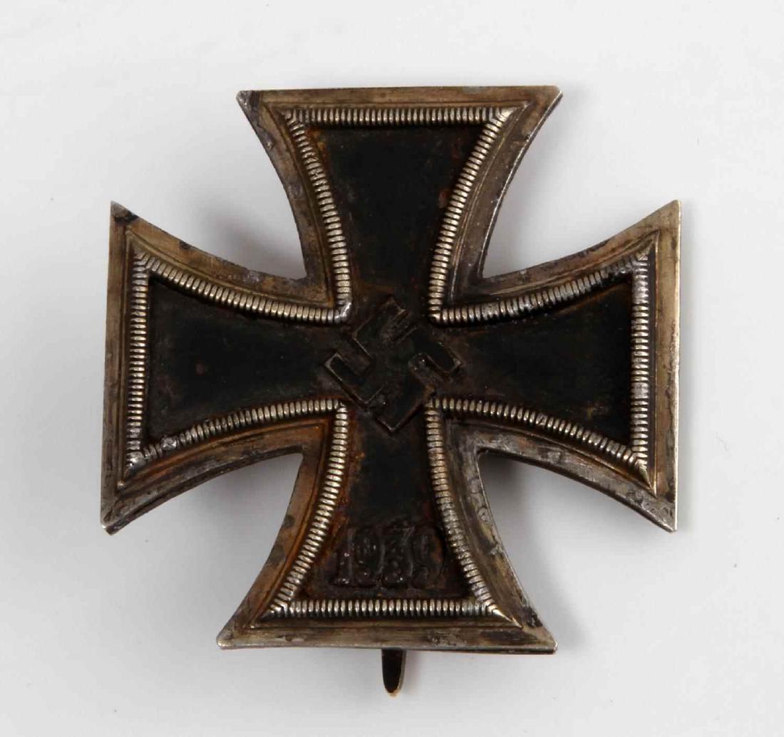 GERMAN WWII FIRST CLASS IRON CROSS 1939 THIRD REIC: Swastika and 1939 to front. Wide vertical pin back with C-hook closure. Four piece construction with an iron magnetic center. No maker's mark. Some oxidation present. Unauthenticated, sold as is.