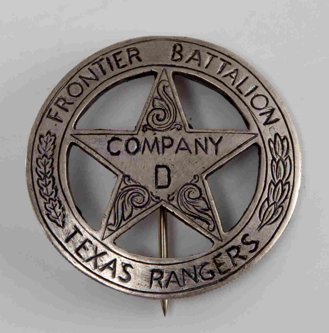 OLD WEST FRONTIER BATALLION TEXAS RANGERS BADGE: Old West Frontier Battalion Texas Rangers mexican peso law badge. Measures 1 5/8" in diameter. Front reads 'Frontier Battalion Company D Texas Rangers'. Leaf design around edge. has a thin vertical pi