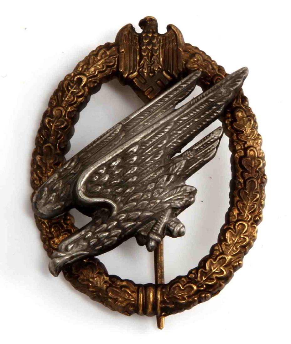 GERMAN WWII ARMY PARATROOPER FALLSCHIRMJAGER BADGE: Jump badge. Reverse maker marked "C E Junker Berlin SW". Thin vertical "T" bar style pin back. Two-piece two domed nickel and brass construction. Unauthenticated. Sold "as is".