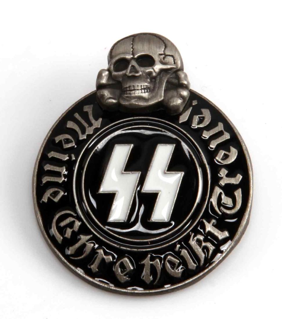 WWII GERMAN THIRD REICH WAFFEN SS PARTY BADGE: Sig Rune and Totenkopf party badge. Measures 1 1/8 inches by 1 5/16 inches tall. The reverse is marked 'ges gesch RZM M13/42 SS'. Has a thin horizontal pin back. Two piece nickel construction with ena