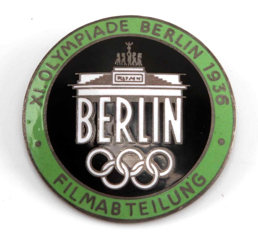 GERMAN WWII 1936 SUMMER OLYMPICS FILM MAKER BADGE: Measures 1 1/2" in diameter. Reverse is maker marked 'Rob Neff Berlin W 57'. Has thin horizontal pin back. One piece nickel construction with lime green enamel. VG condition.