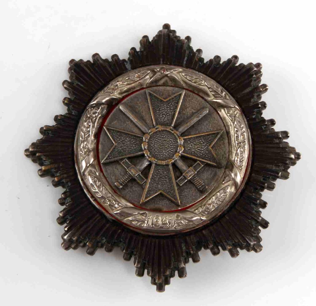 WEST GERMAN WWII GERMAN CROSS IN SILVER 800: Measures 2 1/2" wide by 2 1/2" tall. Front has West German War Service Cross with swords in center. Surrounded by a round nickel oak leaf wreath that is dated '1941'. There is a star burst with eight 