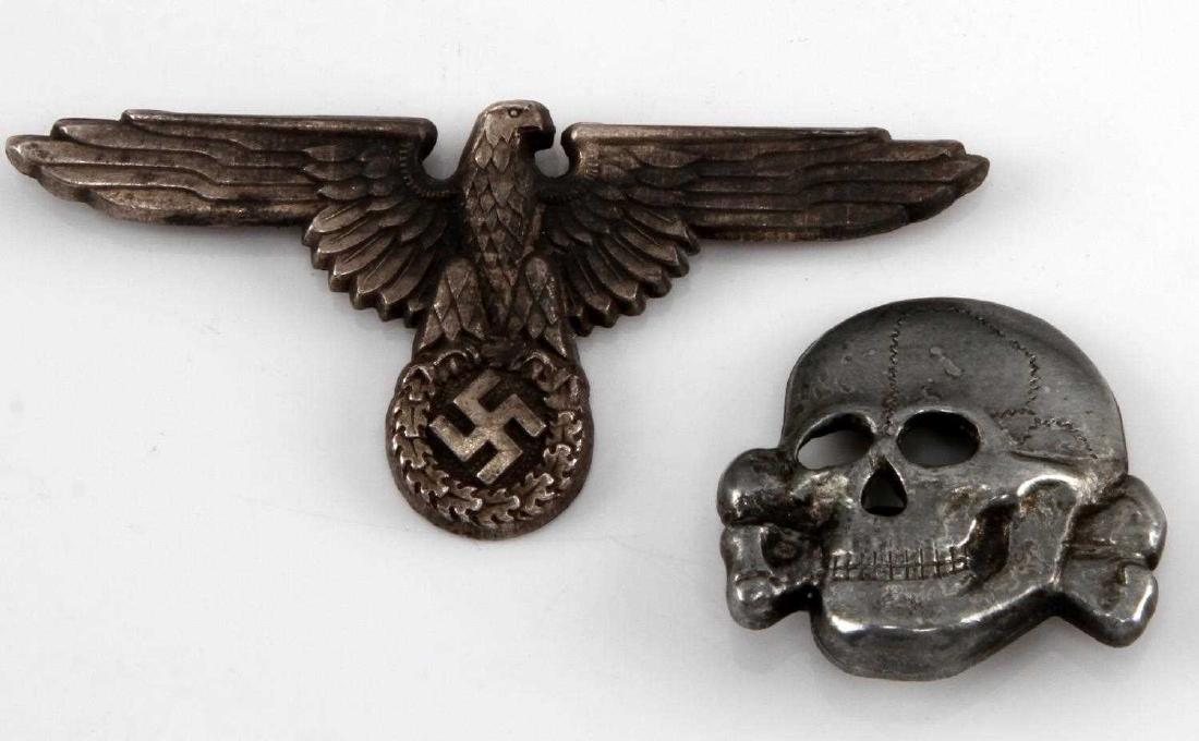 GERMAN WWII WAFFEN SS OFFICERS VISOR EAGLE & SKULL: German WWII Waffen SS Officers visor cap eagle & skull. Reverse of both are marked 'RZM M1/24'. Both feature flat horizontal prongs on their reverse. Stamped nickel construction. Minor tarnishing, VG 
