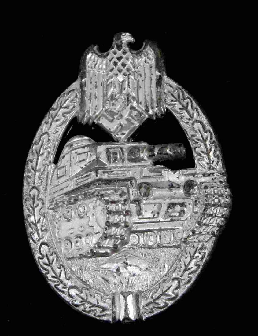 GERMAN WWII PANZER ASSAULT BADGE IN SILVER FLL: German WWII Panzer Assault badge. Silver variant. Maker stamped on reverse 'FLL' and '43'. Has a thin vertical pin back. Nickel construction. Awarded for three combat encounters with enemy. Unauthenti