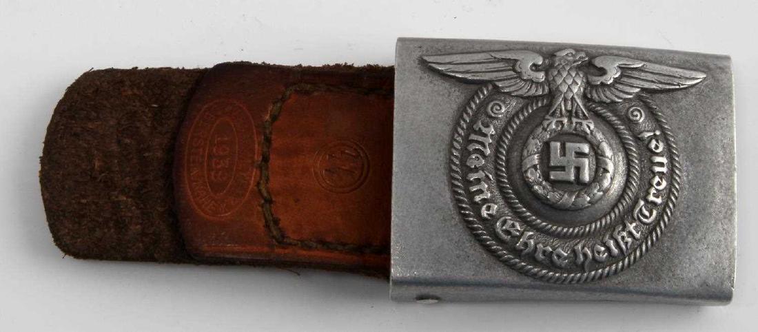 GERMAN WWII WAFFEN SS ENLISTED MANS BELT BUCKLE: Front reads "Meine Ehre heist Treue!". Has waffen SS Eagle above text. Reverse is marked "RZM 36/39 SS". Includes attached leather tab that is marked "Lind & Meyer 1939 Oberstein/Nahe". Pre-war alumin
