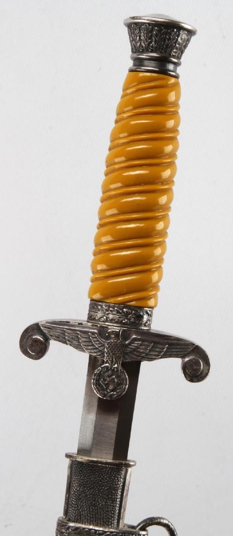 WWII GERMAN THIRD REICH ARMY OFFICER DAGGER: Dagger and scabbard with 2 suspension rings. Measures 15 1/2 inches long overall. Blade has no pitting but some discoloration. Maker marked F W Holler Berlin. Has their thermometer logo. Orange cellul