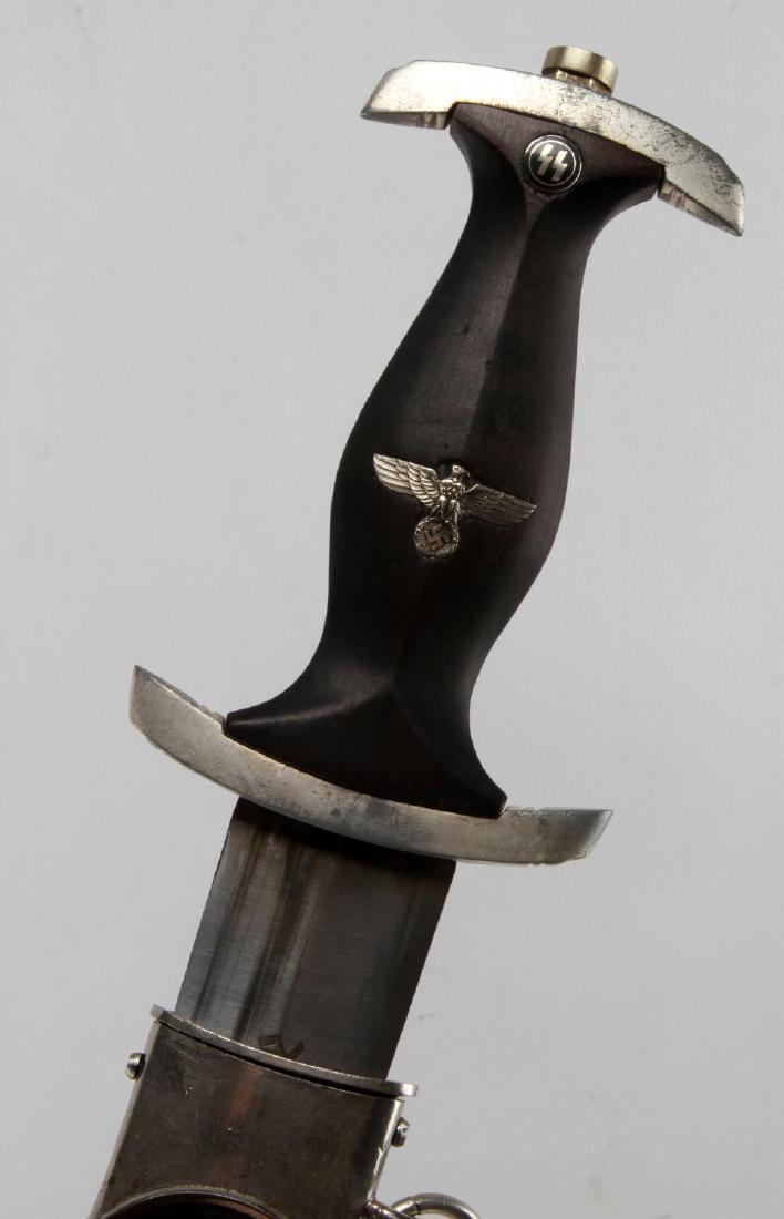 WWII GERMAN 3RD REICH SS SCHUTZSTAFFEL EM DAGGER: Dagger with scabbard and suspension ring. Measures 14 /3/4 inches long overall. Blade has no pitting but does have some discoloration or tarnish. Blade is marked Joseph Wolf Munchen AU (scarce maker) 
