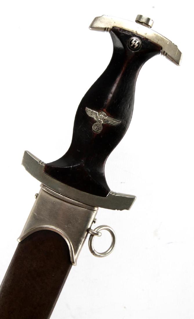 WWII GERMAN THIRD REICH SS HIMMLER HONOR DAGGER: Dagger and scabbard with suspension ring. Measures 15 inches overall. Reverse side reads Comradeship, H. Himmler in German. Makers marked Carl Eickhorn Solingen with squirrel logo. Blade has tarnish a