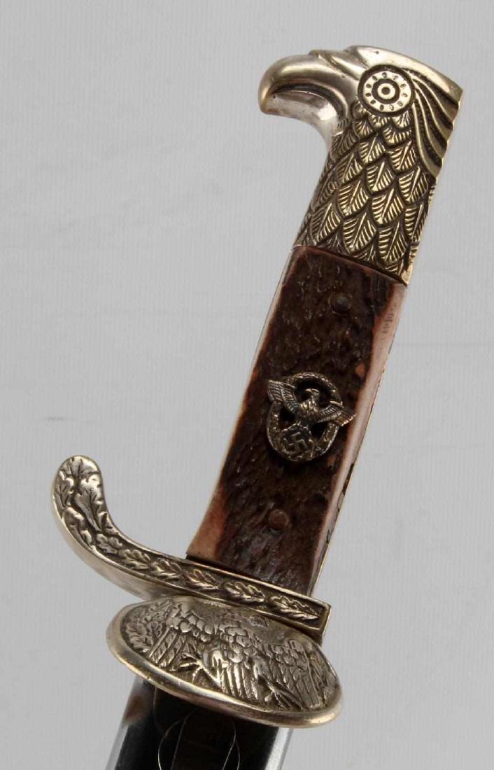 WWII GERMAN THIRD REICH POLICE DRESS BAYONET: Police Bayonet with Scabbard. Clam shell guard with eagle. Measures 20 3/4 inches overall. The steel blade is unmarked. It measures 1 inch wide by 16 inches long. Has a pair of stag antler grips with