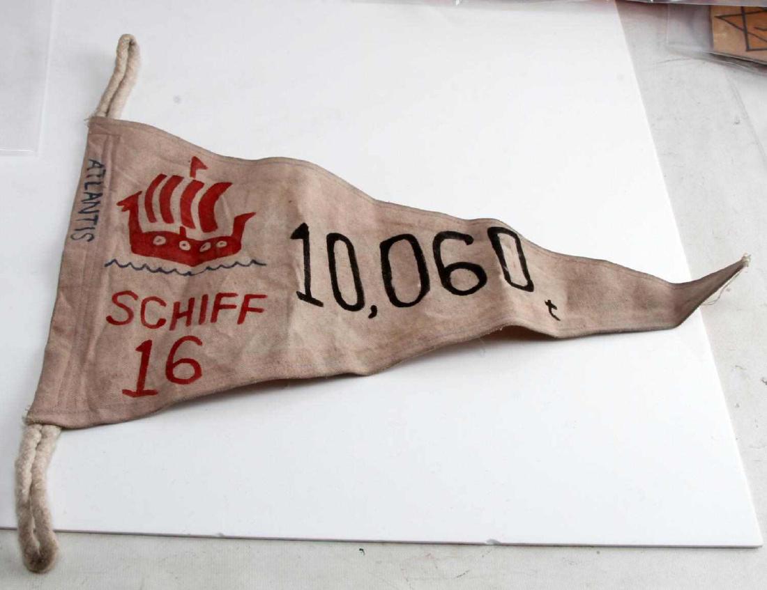WWII GERMAN THIRD REICH NAVAL E BOAT KILL FLAG: Measures 18 inches wide by 10 1/2 inches tall. The front shows a hand-painted Viking ship and reads "Atlantis Schiff 16 10,600 t" in black, red, and blue paint.Has two rope eyelets on one end for hang