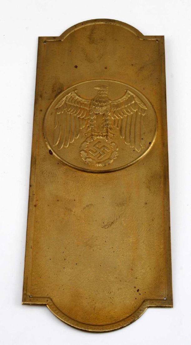 GERMAN WWII POLITICAL LEADER BRASS DOOR PLAQUE: German WWII political leader brass door plaque. Displays eagle insignia centered. Measures 3 3/4" wide by 10 1/16" in height. Stamped brass construction. VG condition, minor spotting.