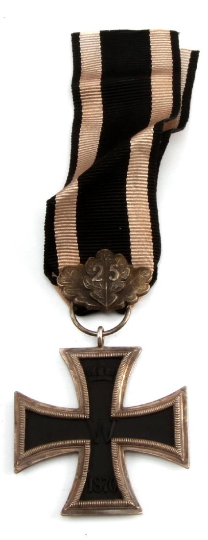 IMPERIAL GERMAN PRE WWI 1870 2ND CLASS IRON CROSS: With 25 year jubilee oak leaf cluster and presentation ribbon. Three-piece construction with an iron magnetic center. A rare decoration from the 1870-1817 Franco Prussian War. Unauthenticated. Sold "a