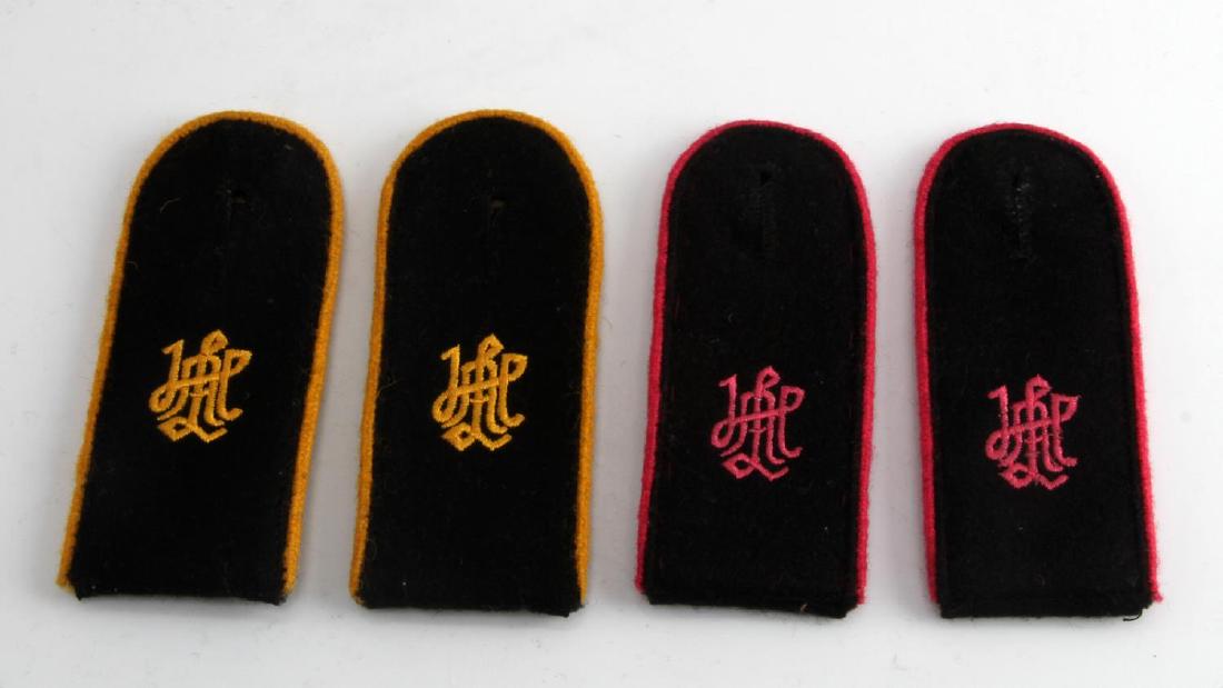 WWII GERMAN THIRD REICH SS LAH SHOULDER BOARD LOT: Lot contains two sets of Waffen SS Leibstandarte Adolf Hitler cypher shoulder boards. All measure 1 7/8 inches wide by 8 5/16 inches long. One set has pink panzer piping, while the other has yellow ca