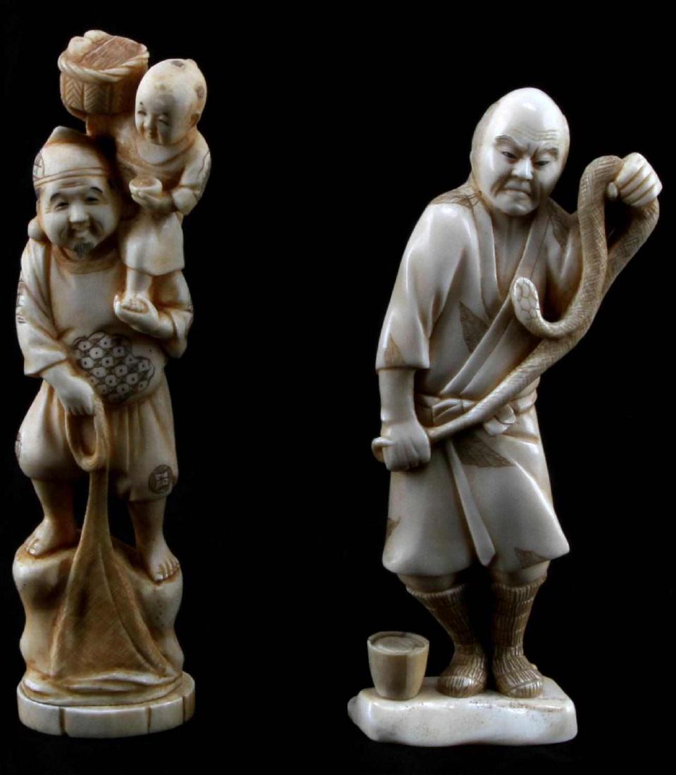 MEIJI JAPANESE CARVED WALRUS TUSK FIGURE LOT OF 2: Lot contains two small sculptures carved out of walrus tusk. One depicts a bald man holding a snake. The other depicts a man with a hat on holding a boy on his shoulder and holding what may be a fishi