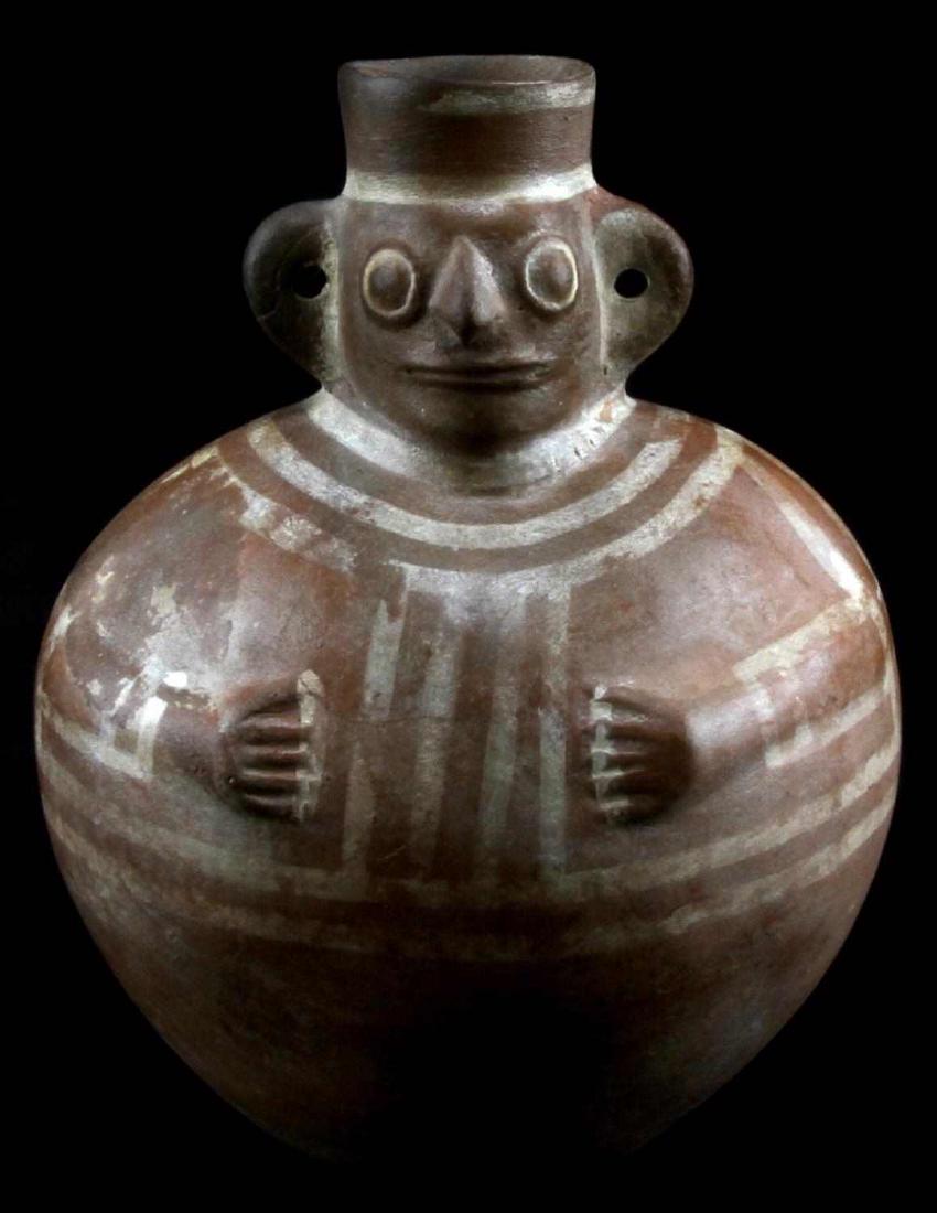 ANTIQUE NATIVE AMERICAN HUMAN EFFIGY CERAMIC JUG: Ceramic jug with an effigy of a human face on the stem, arms on the body, and the ears of the jug making the ears of the person. Measures 8 inches in height and 6 inches in width.