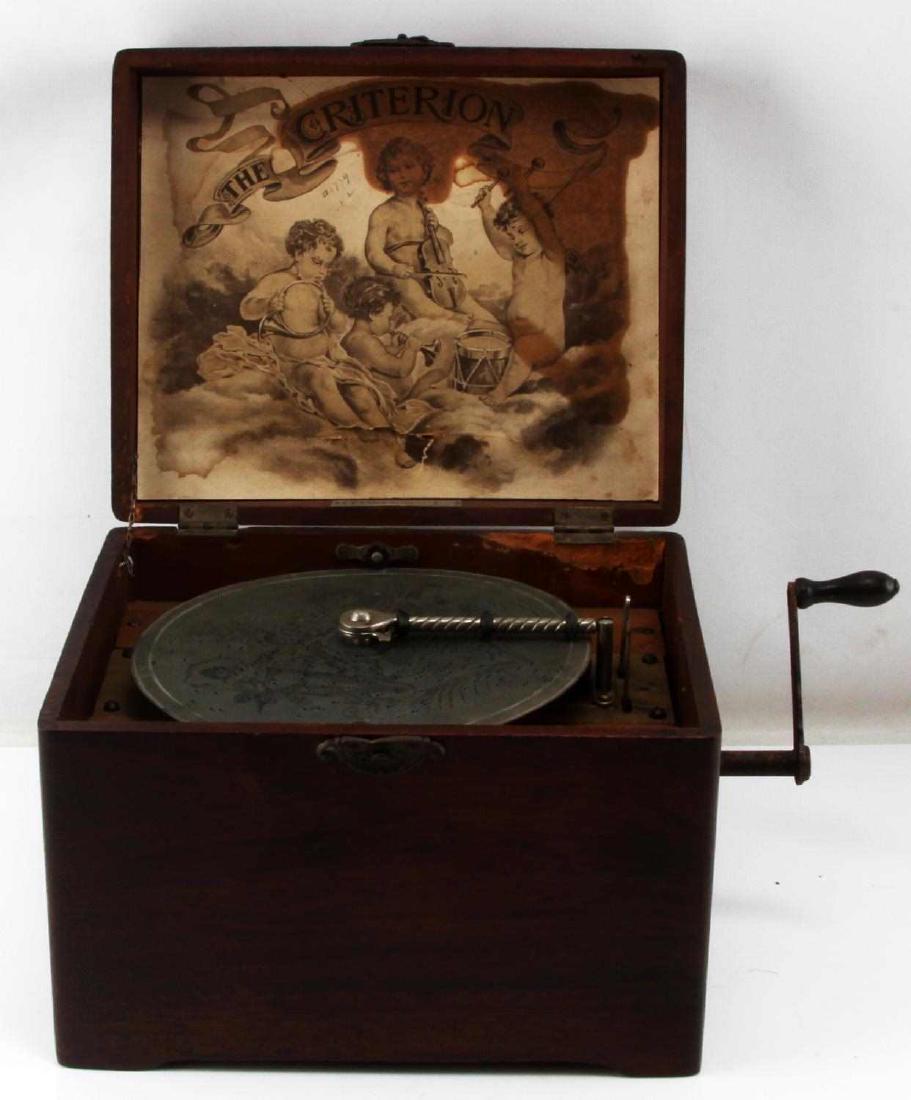 ANTIQUE MAHOGANY DISC MUSIC BOX CRITERION 1: Criterion 1 series with one disc. The crank is operational, motor works but music does not play (comb is absent.) Measurements: 12x9x10 inches, mahogany wood box has some indentations scratches and lo