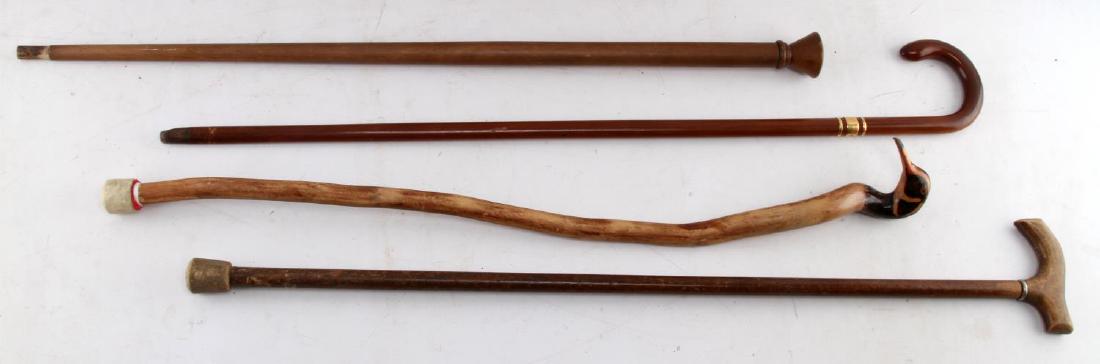 LOT OF 4 VINTAGE TO ANTIQUE WALKING STICKS & CANES: All items are intricately carved & made with artisan detail, one of the canes bears a gold locket marked "MBS " with another marking near the horn ferrule which reads "made in England". Item is in goo