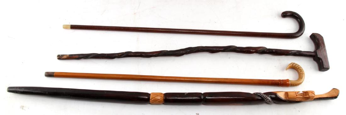 LOT OF 4 VINTAGE TO ANTIQUE WALKING STICKS & CANES: Grouping of 4 vintage to antique walking sticks & canes which include: African animal themed cane painted carved wood depicting coiled snake which becomes handle and is painted with white dots carved 
