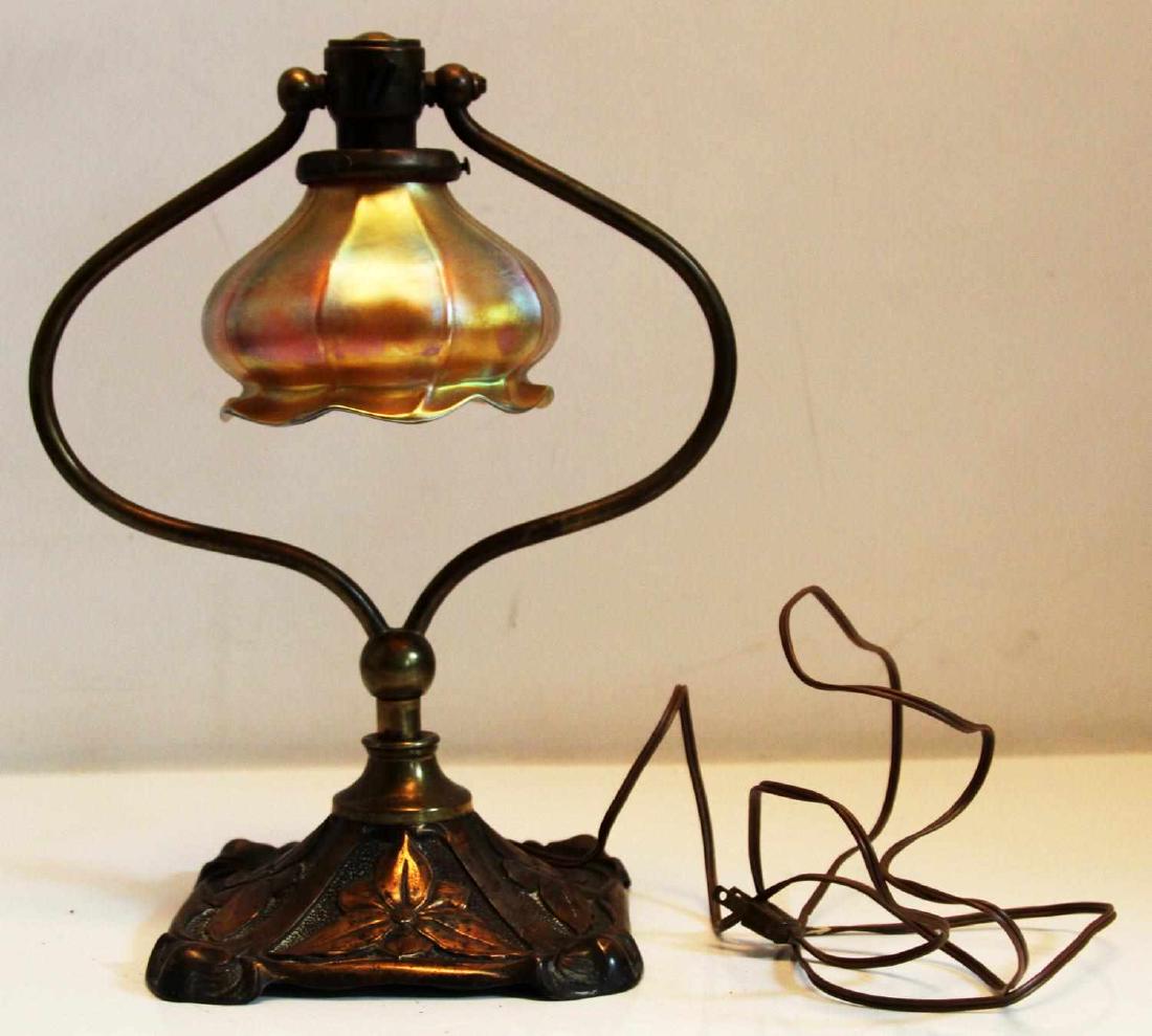 ANTIQUE TIFFANY STYLE DESK LAMP W SWINGING SHADE: Unmarked floral arts and craft style base with swivel shade also unmarked, was rewired at some point and appears functional, measures 14 by 11 inches.