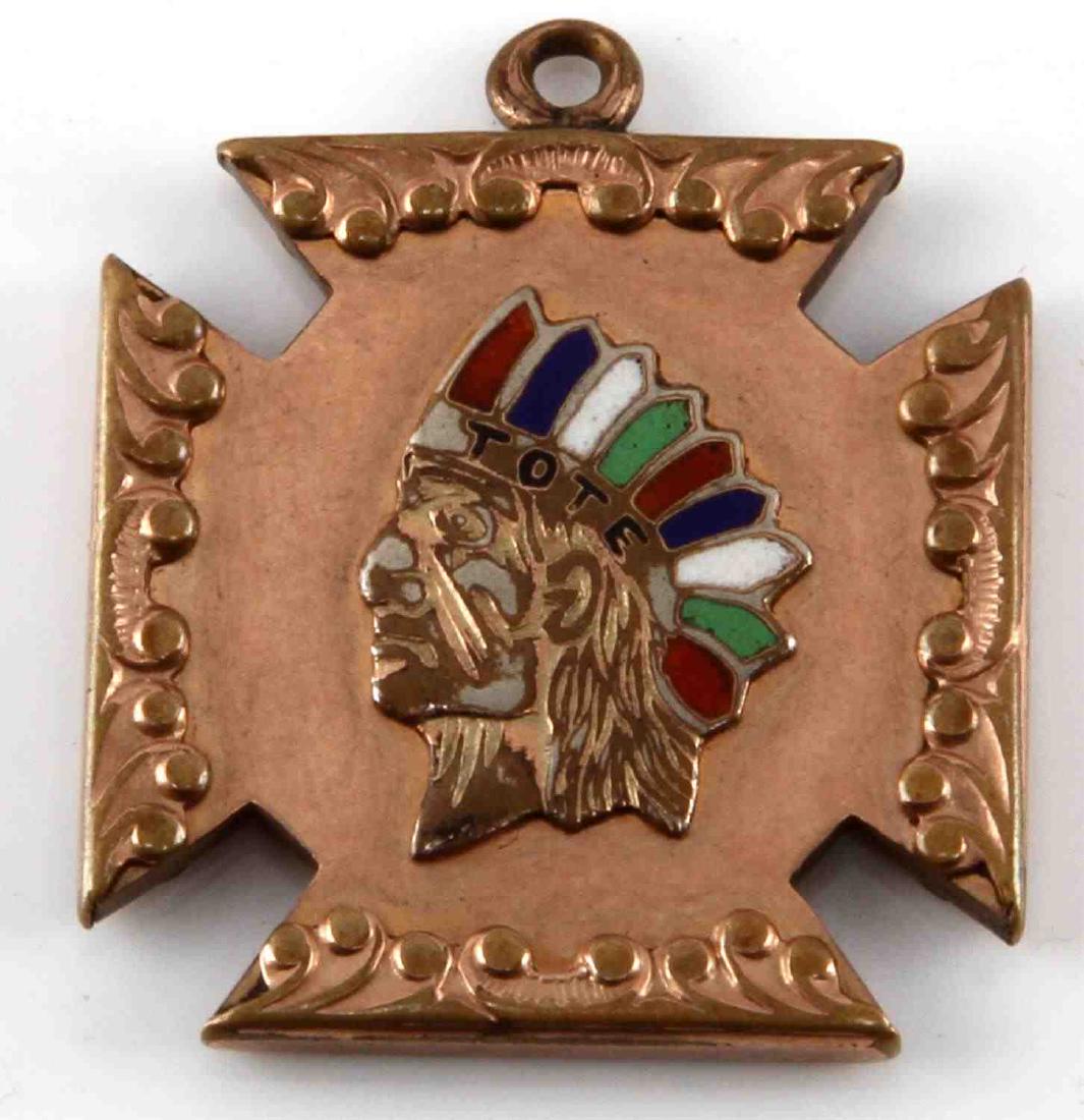 10KT YELLOW ROSE GOLD NATIVE INDIAN PENDANT: Raised relief Native American Indian in headdress that reads TOTE with colored inlay, yellow gold scrolling and rose gold background.. In good condition, pre-owned with contact wear. Total weight 9 gr