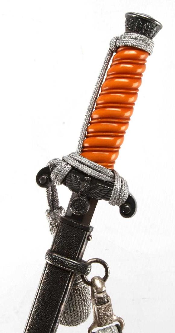 WWII GERMAN THIRD REICH ARMY OFFICER DRESS DAGGER: Dress dagger of a German Army officer. Orange bakelite grip. The blade is marked 'Alcoso Solingen'. Includes wire-wrapped silver portepee and hanger. Back of hanger is marked 'D.R.G.M.'. In very good 