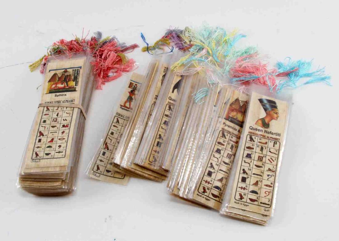 LOT OF OVER 200 EGYPTIAN PAPYRUS GLIPHIC BOOKMARKS: Grouping of over 200 Egyptian Papyrus Heirogliphics bookmarks depicting the Ancient Egyptian alphabet as heirogliphics. Items are in good condition with plastic casing and tassel.