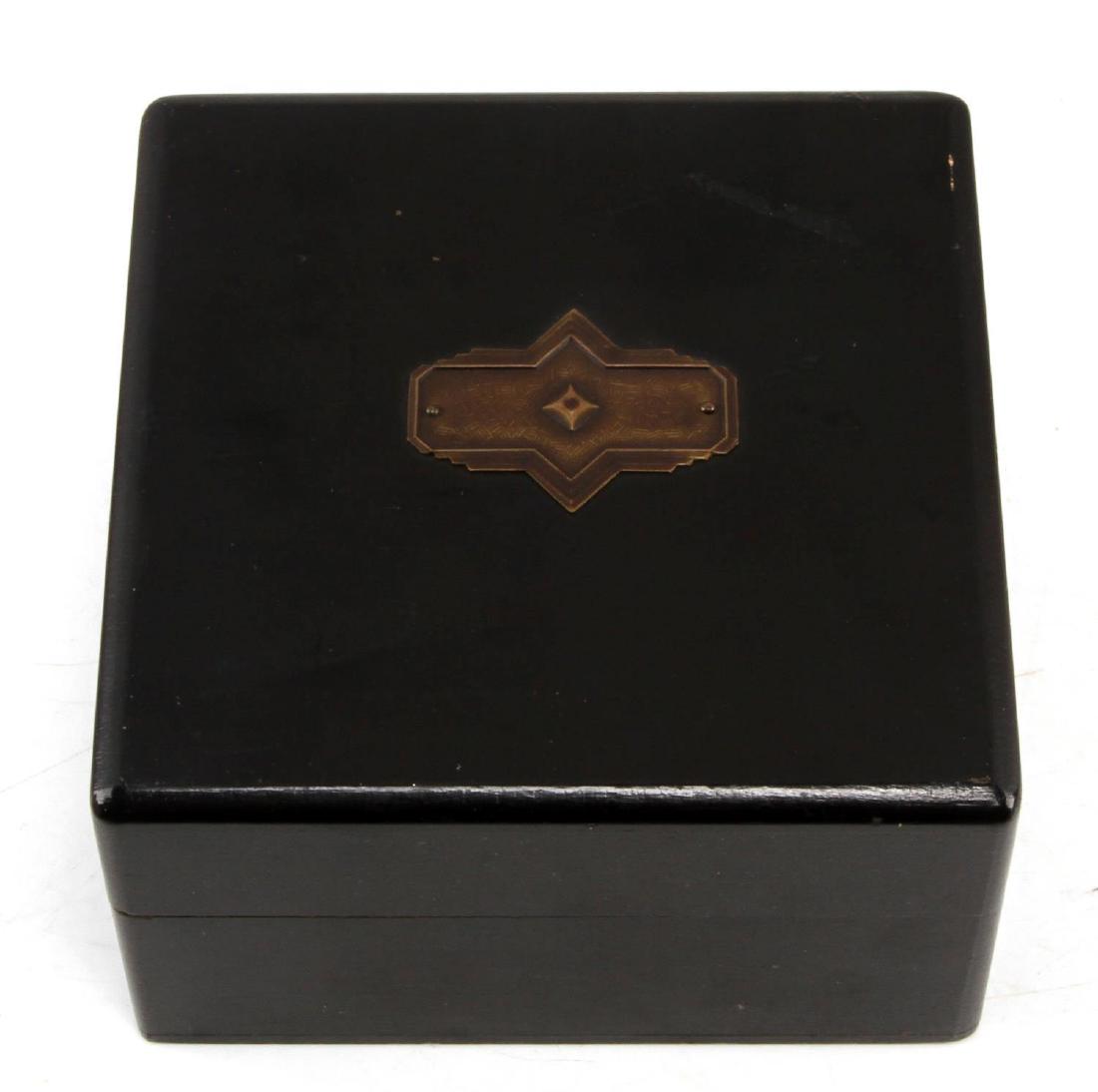 VINTAGE ART DECO EBONIZED WOOD TRINKET BOX: Vintage trinket box made of ebonized wood with an art deco designed plaque on top. Measures about 4 1/2 inches square by 2 1/2 inches tall. In very good condition with minor scratching.