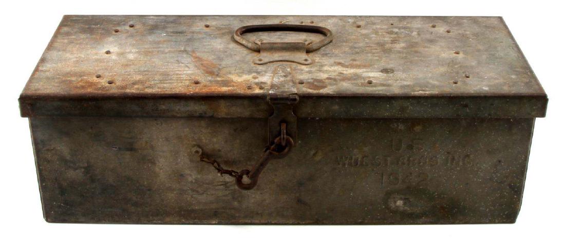 LARGE US MILITARY BOX 1942 FILLED W MILITARY ITEMS: Metal tin box is marked "U.S WUEST BROS INC" and is filled with a US military jeep water carrier with a rope tie, military cavalry stirrup, belts, ties and other military issue fastening items. Items 