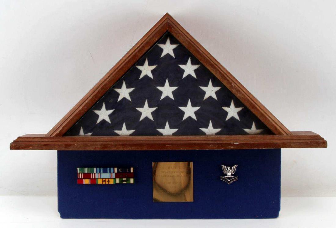 AMERICAN VETERANS MEMORIAL BURIAL FLAG W PLAQUE: Plaque reads, "UT2 Richard L. Gwin Transferred to Fleet Service 31 Oct 1985, Fair Winds And Following Seas" with eagle pin to right side and ribbon bar ranks to left side. Good condition.
