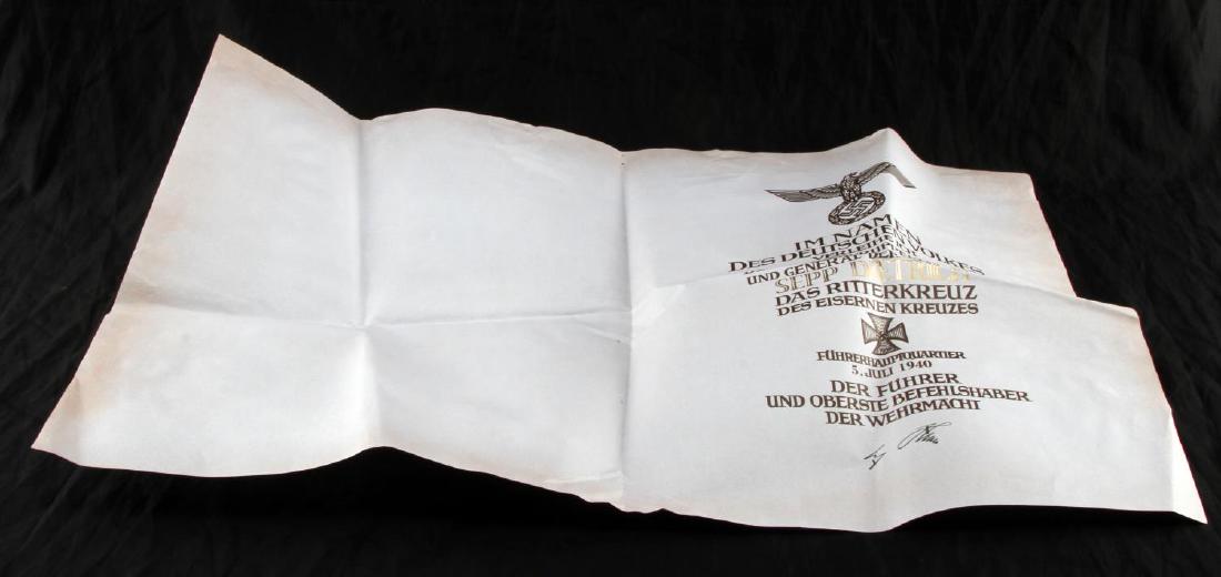 SEPP DIETRICH GERMAN WWII KNIGHTS CROSS PAPER: Knights cross paper. Made out to Sepp Dietrich, Commanding Officer Oberst-Gruppenfuhrer in the Waffen SS. Seen at bottom is signature for Hitler. Document measures 17" x 27". Unauthenticated, sold as