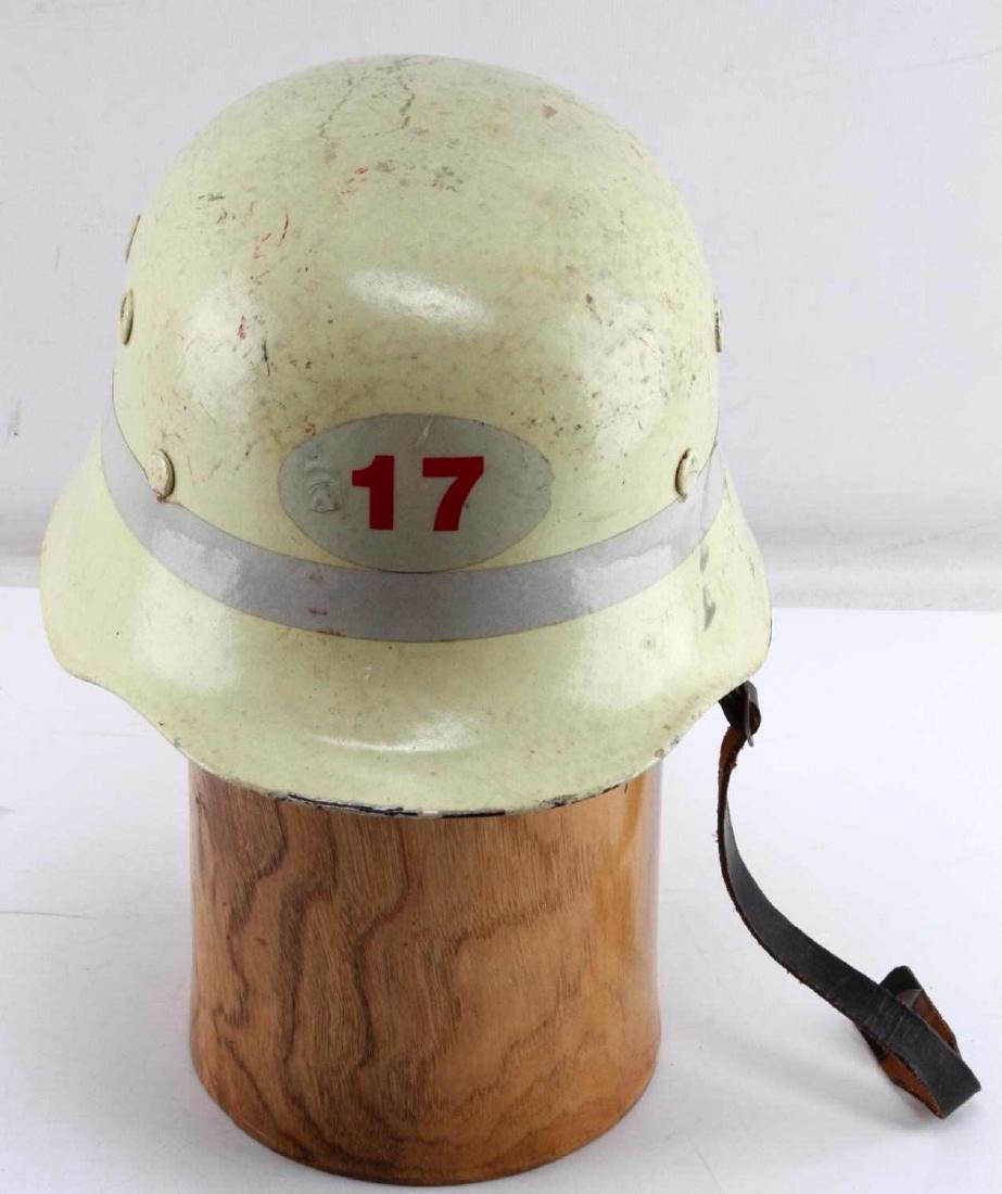 GERMAN WWII FEUERWEHR FIREMANS HELMET: German WWII Fire civil-type helmet. Has yellow neon paint that was most likely added post war. Features an original leather liner and chin strap. Marked 17 on front face. Light wear, VG condition.