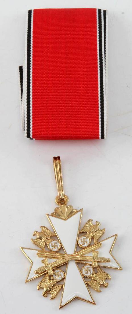 GERMAN WWII ORDER OF THE GERMAN EAGLE W RIBBON: German WWII Order of the German Eagle 1st class. Bears white enamel, crossed swords, and a reverse with maker mark 'MUNCHEN 9'. Included is 23" presentation ribbon. Overall VG condition. Unauthenticat