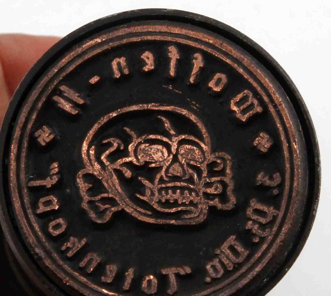 WWII GERMAN THIRD REICH WAFFEN SS HAND STAMP: Hand stamp of the 3rd SS Panzer Division "Totenkopf". Has said Totenkopf in the center of the stamp. In very good condition. Measures 4 1/2 inches tall and 1 1/2 inches at the stamp end. Unauthenticat