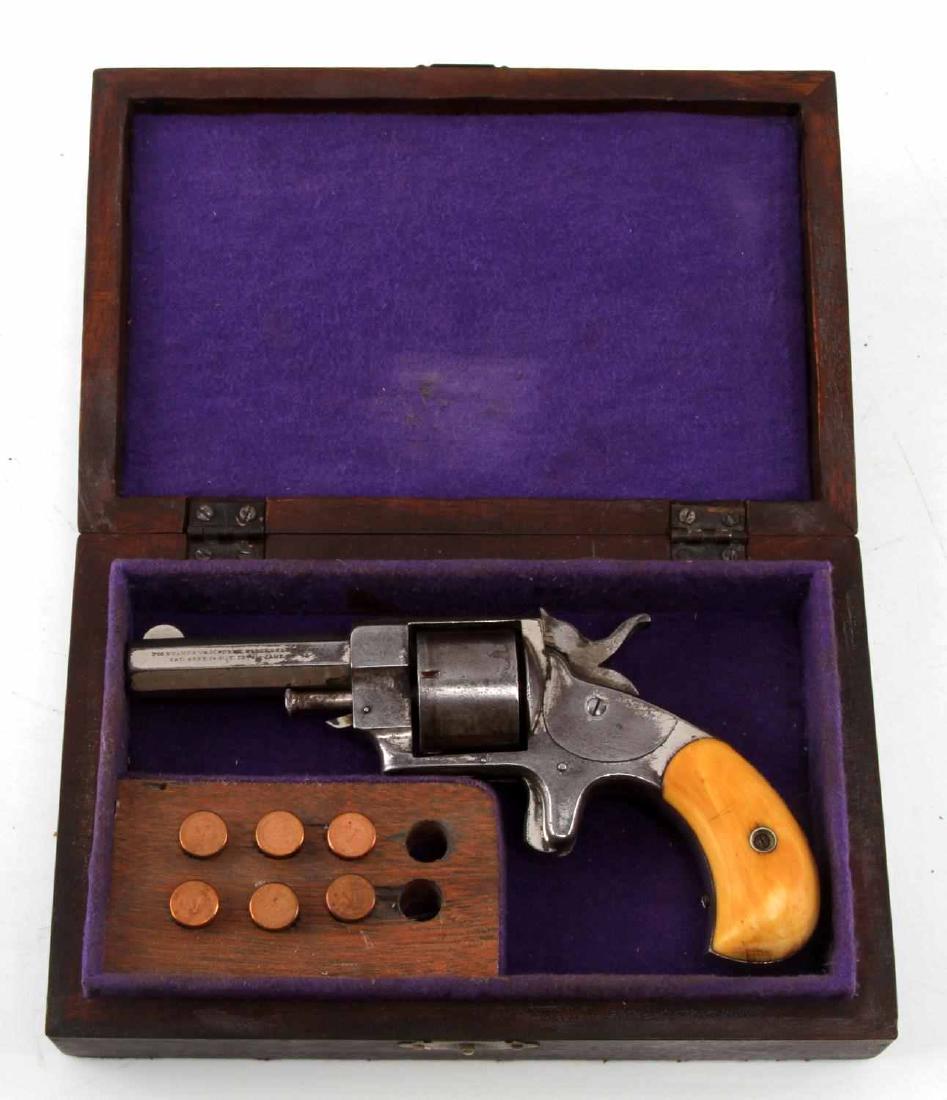 ANTIQUE SWAMP ANGEL REVOLVER ELEPHANT TUSK GRIPS: Rimfire .41 caliber Swamp Angel pistol. Pistol has carved elephant tusk grips. Includes a block containing 6 .41 caliber rounds, each of which has a 'V' stamped on the bottom.. Pistol is in generally