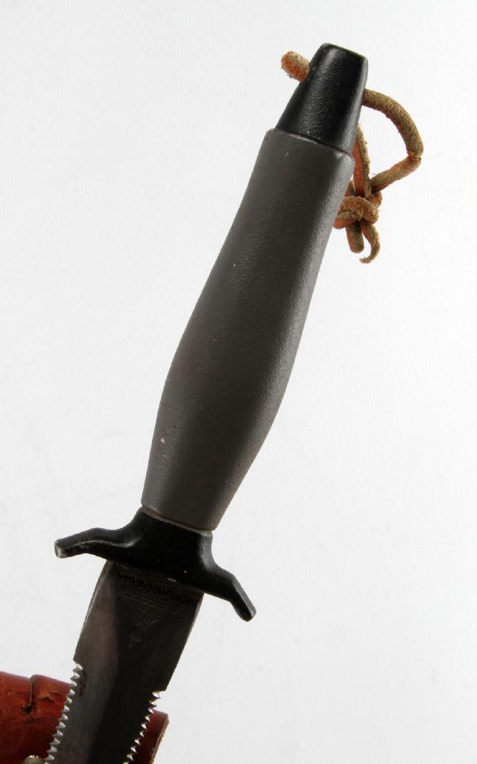 VIETNAM TO PERSIAN GULF GERBER MARK II KNIFE: A Gerber Mark II survival and fighting knife. Includes the leather sheath and Gerber honing steel. In very good condition, with minor wear of the grip, as well as some scuffing and wear of the leather