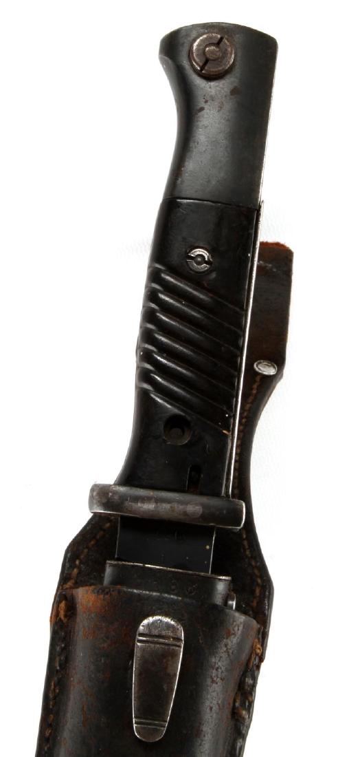 WWII GERMAN THIRD REICH K98 MAUSER BAYONET LOT: A K98 Mauser bayonet, along with scabbard and leather frog. Blade measures 9 3/4 inches in length. Bakelite grips, and the ricasso of the blade is marked '41cof' and '126 i'. Scabbard has some wear mi
