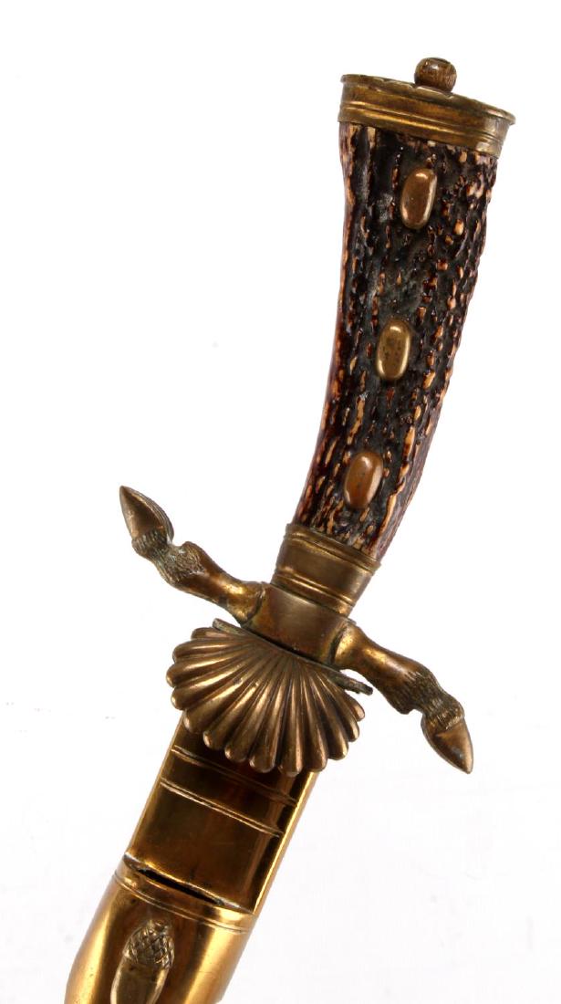 WWII GERMAN THIRD REICH HUNTING ASSOCIATION DAGGER: German Hunting Association Dagger. Antler handle. The black leather wrap around the outside of the scabbard has worn away, and the second miniature dagger is missing. Has a WKC maker mark under the cl