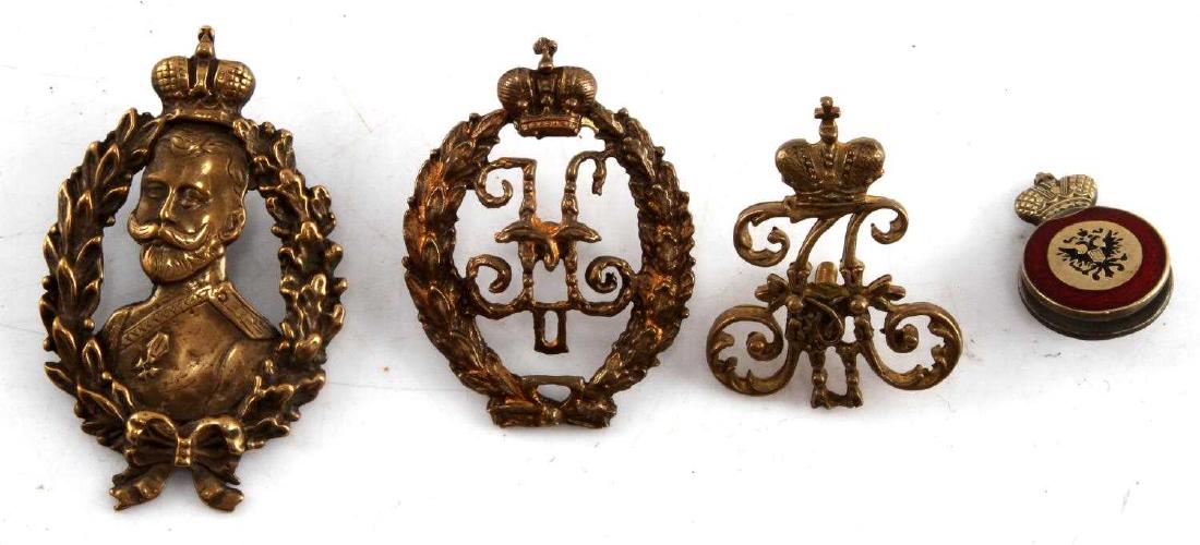 IMPERIAL RUSSIA TSAR BADGE LOT OF FOUR: Lot contains four badges from the Imperial Russian era. One is a badge depicting Tsar Nicholas surrounded by a wreath and topped by the Imperial crown. Second is a badge with the royal cypher of Tsar 