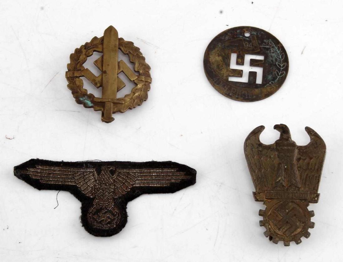 GERMAN WWII HITLER DISC SS PATCH & BADGE LOT OF 4: German lot of 4 items. Includes Adolf Hitler 1943 brass disc, SS eagle patch, Dr. Fritz Todt badge, and a SA Sports badge (serial 226463). Not all items in lot could be authenticated, sold as is.