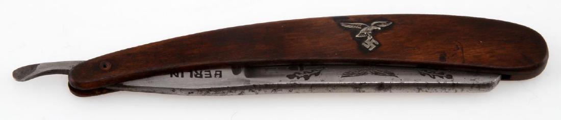 GERMAN WWII LUFTWAFFE PILOTS SHAVING RAZOR BERLIN: German WWII Luftwaffe Pilot's straight shaving razor. Wood handle. 3" blade and handle displays Luftwaffe eagle. Blade also marked 'Berlin'. VG condition. Unauthenticated, sold as is. This lot has a r