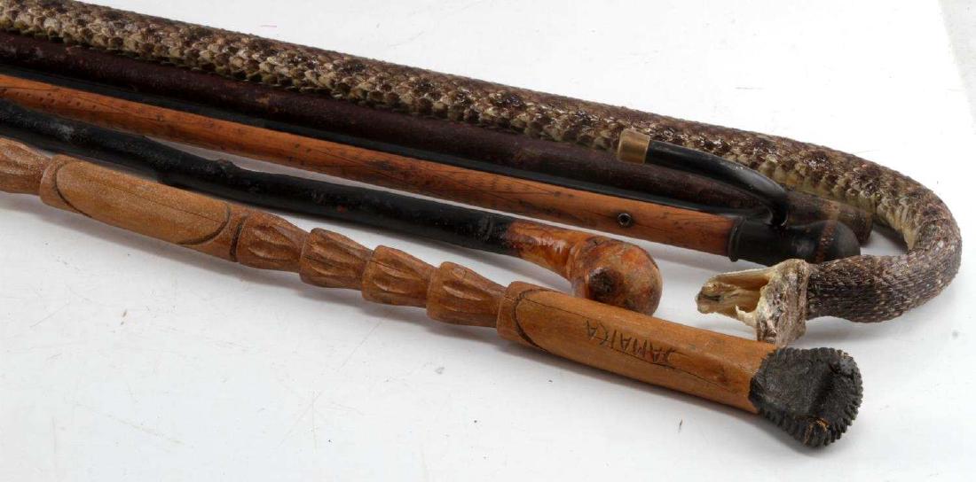 ANTIQUE WALKING STICK COLLECTION OF 6 DIFFERENT: Good variety to include 38 inch rattlesnake, 39 inch Jamaica primitive, Native American Pacific Northwest carve 35 inch, folk art 34 inch, 2nd 35.5 inch folk art, and a metal advertising ringmaster st