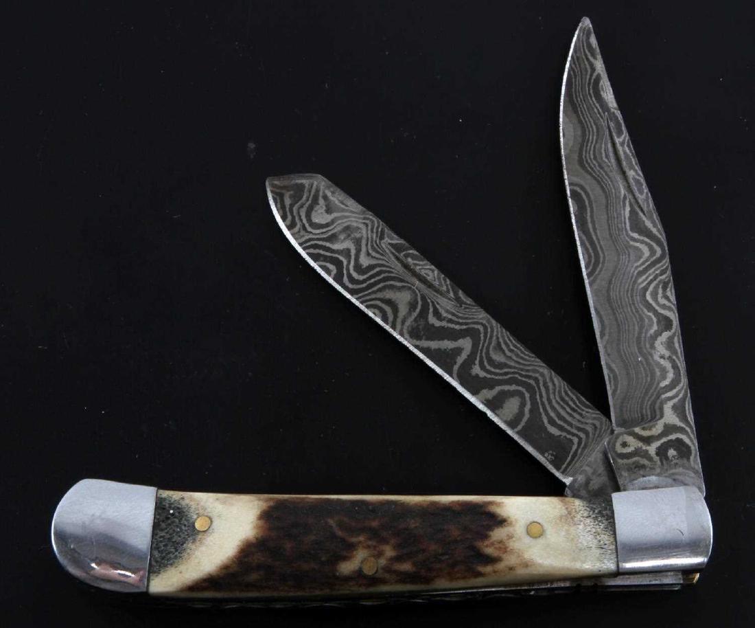 ANTIQUE 2 BLADE DAMASCUS CAMEL BONE POCKET KNIFE: Antique 2 blade Damascus Camel Bone Pocket Knife, twin blades are both made of jelly roll Damascus steel with an etched spine. This antique knife measures 4.5 inches in length closed and 7.5 inches in