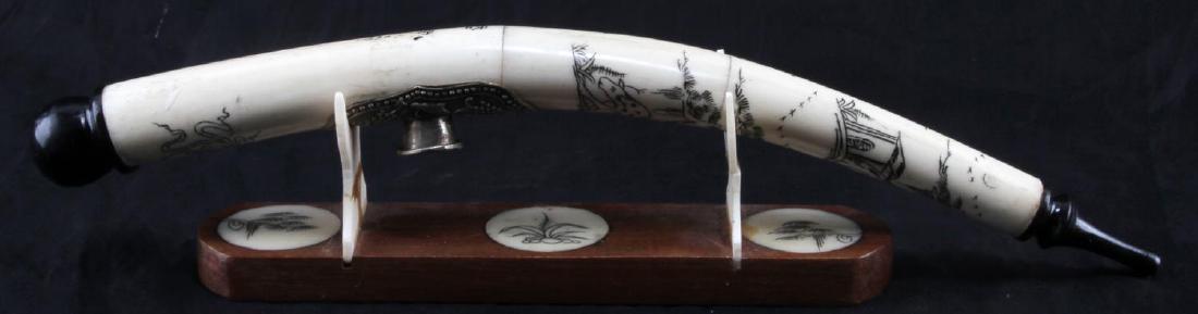 SCHRIMSHAW BONE CHINESE OPIUM PIPE W STAND: Signed, scrimshawed Chinese landscape and figural scenes. Embossed white metal saddle, wood and bone bowl, in good condition. Stand is bamboo and carved bone and has been poorly repaired. Measurements