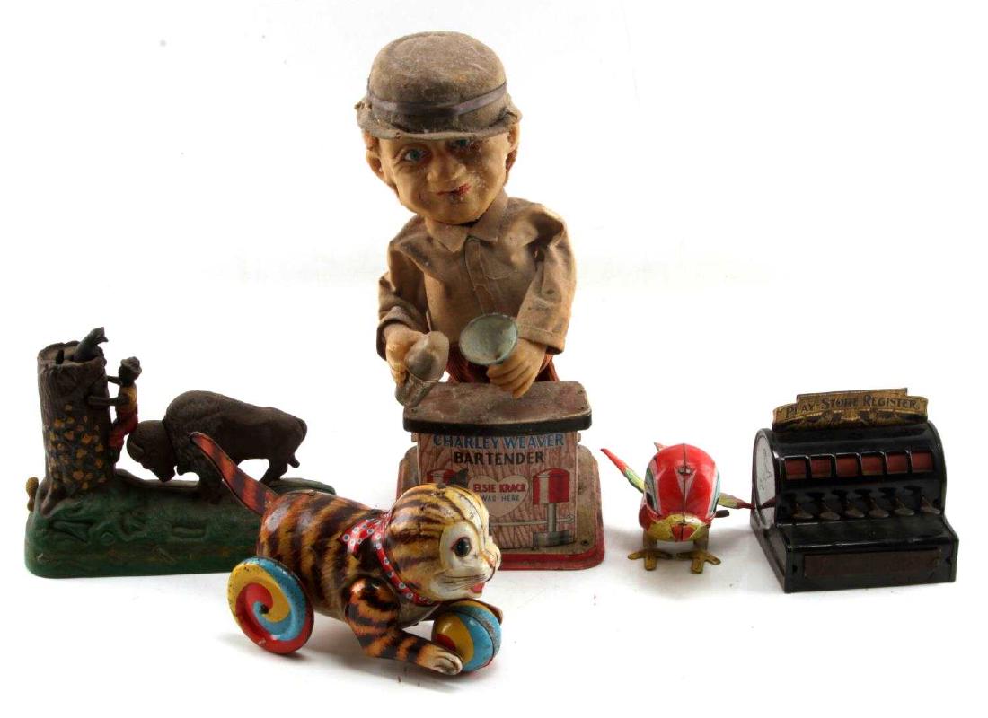 VINTAGE AND ANTIQUE CAN IRON TOY LOT OF 5: Lot contains five vintage and antique mechanical toys. Includes a Charlie Weaver Bartender merchant doll, a Play-Store Register, a Book of Knowledge reproduction of the Butting Buffalo mechanical coin